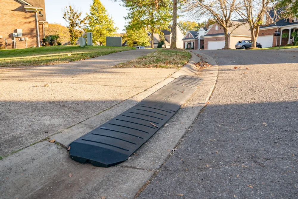 Smooth Curb™ driveway curb ramp placed in driveway curb.