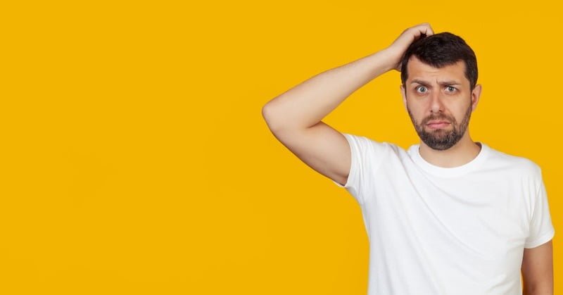 A Worried Man Who Just Hit The Front Passenger Side Of His Car On A Curb A worried man who just hit the front passenger side of his car on a curb.