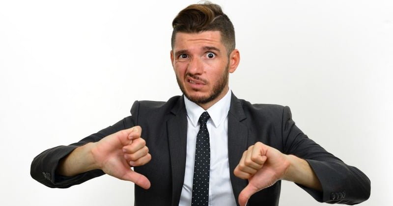 a person putting a thumbs down sign