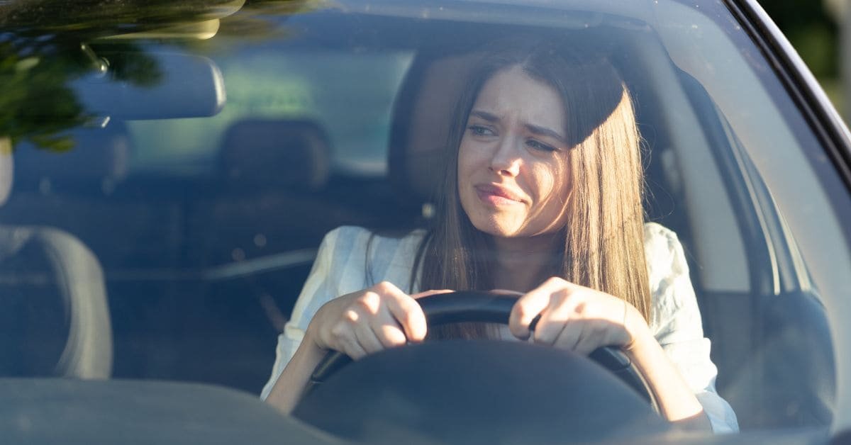 a worried driver that's looking through the mirror