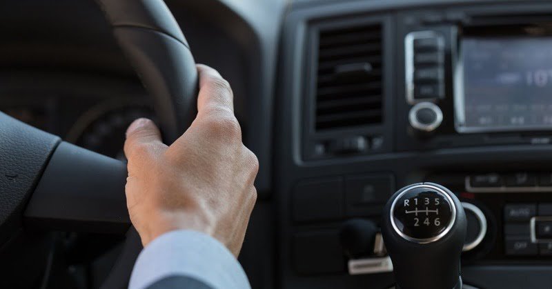 a zoom in photo of a steering wheel and shifter
