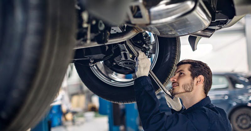 mechanic fixing a car's suspension