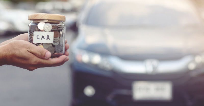 an image of a jar full of coins and a car on the background, giving the metaphor of it being related to car expenses