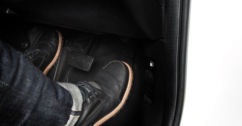 person stepping on the gas pedal