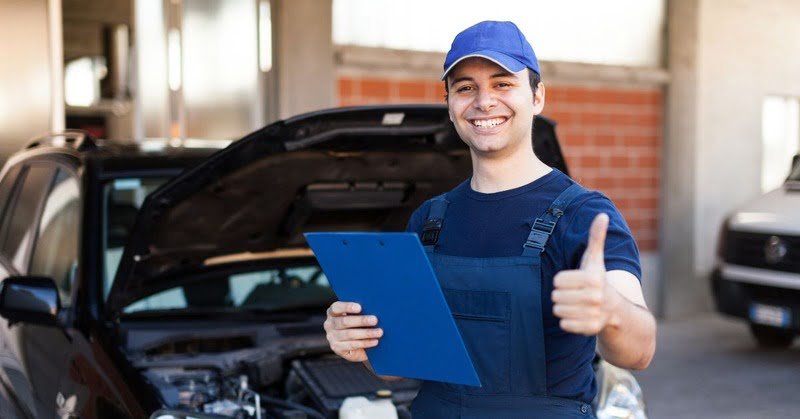 a car mechanic that's giving a thumbs up
