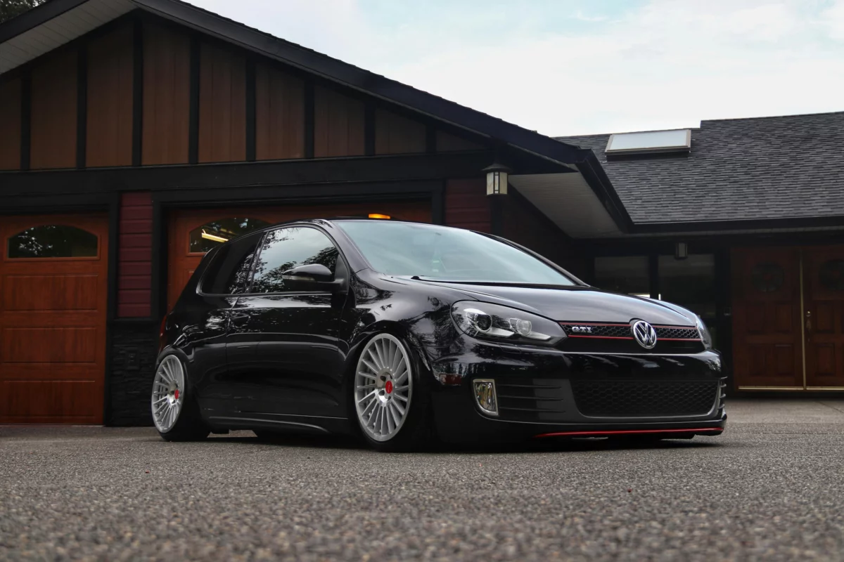 A Black Volkswagen Golf VI GTI Parked in front of a House