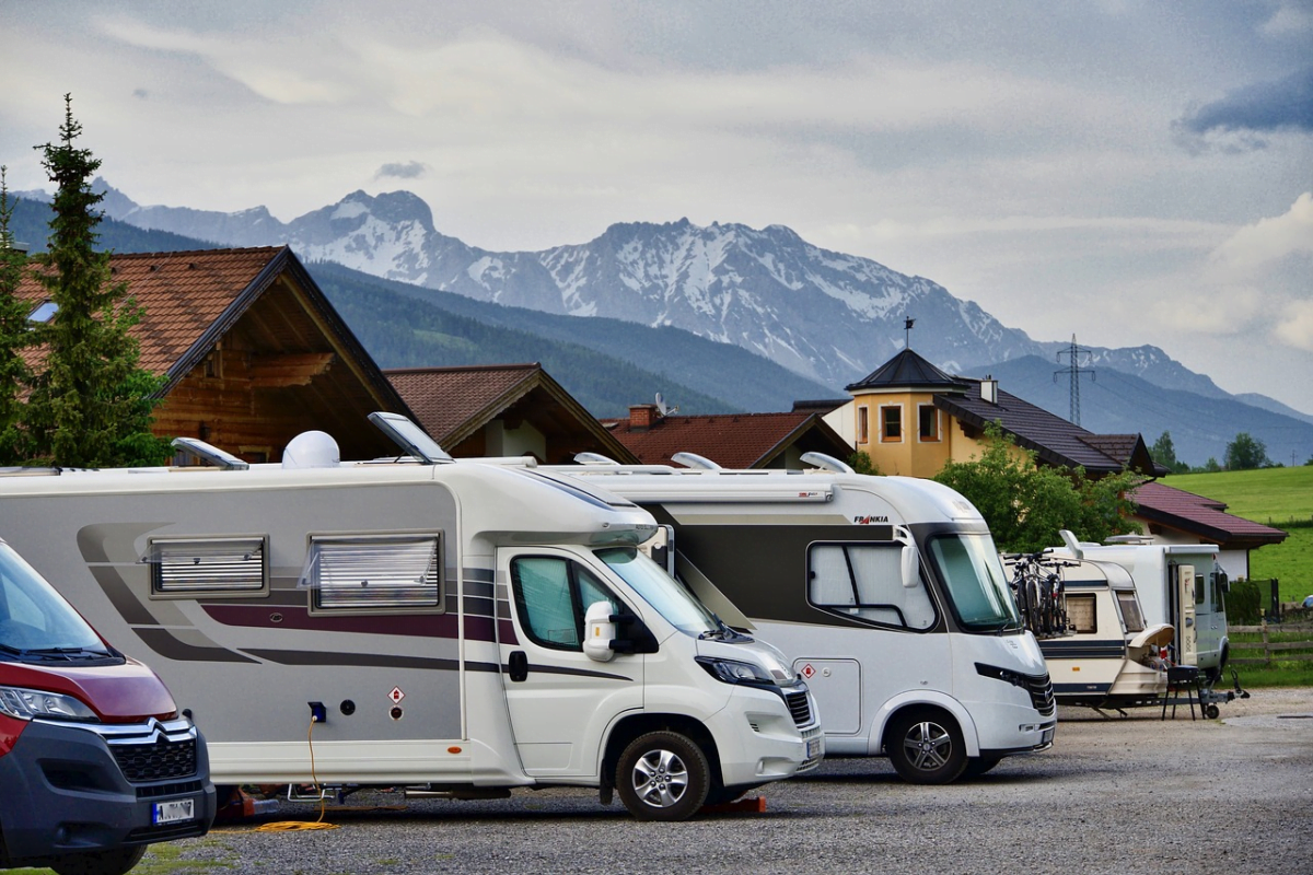 A line of RVs parked in a lot.