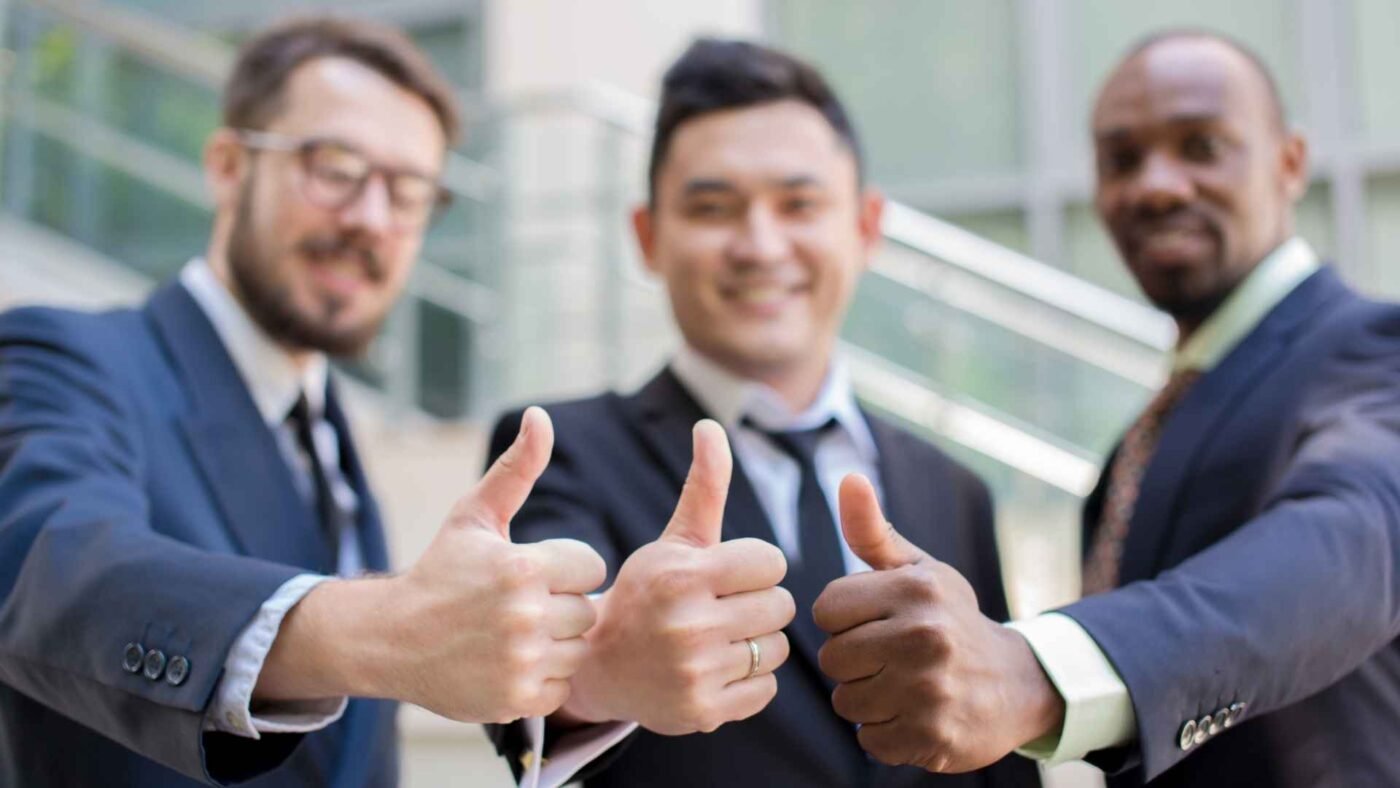 Close Up Of Business Team Holding Their Thumbs Up