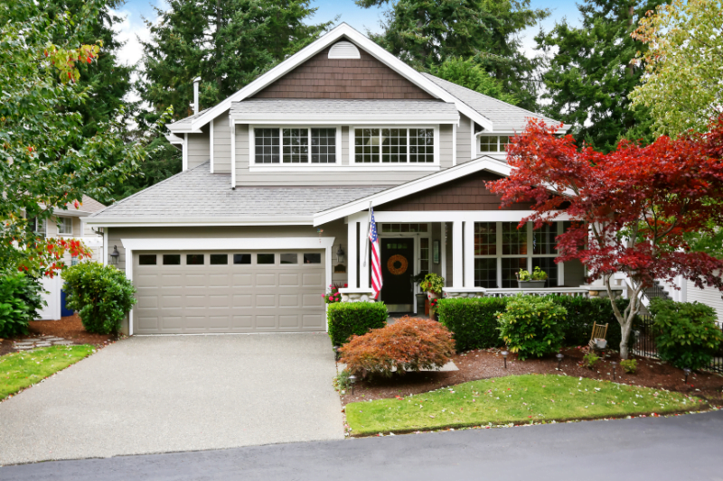 Nice curb appeal of grey house with covered porch