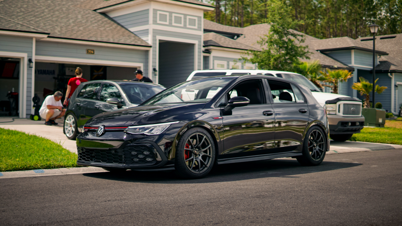 A low Volkswagen Golf GTI R32 parked on a driveway.