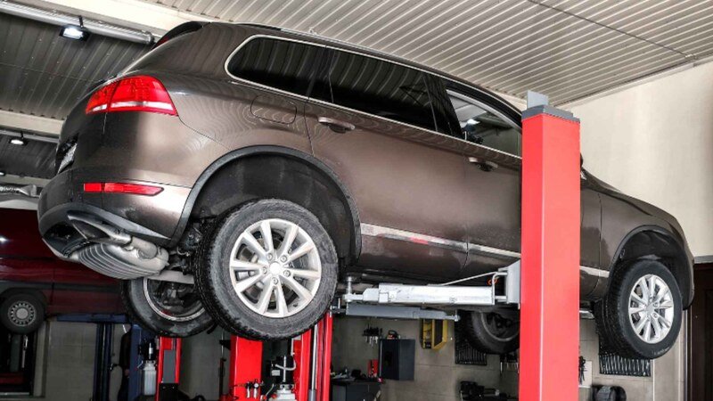 Car On Hydraulic Vehicle Lift In Garage