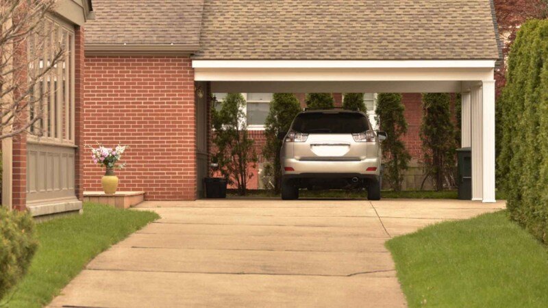 Carport With Parked Car And Nicely Maintained Grounds