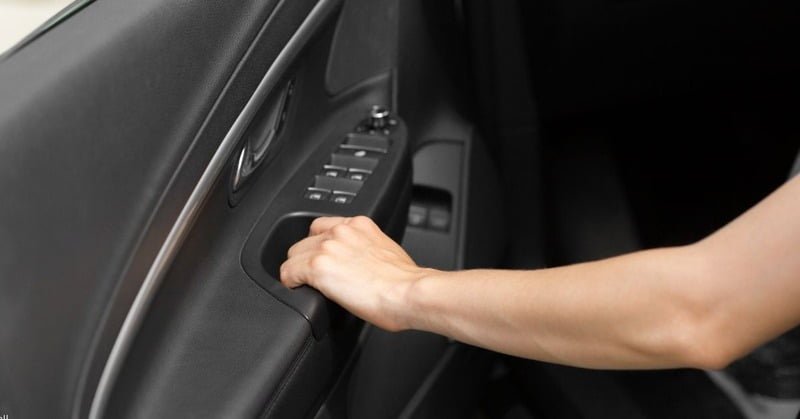person opening up the door of their car