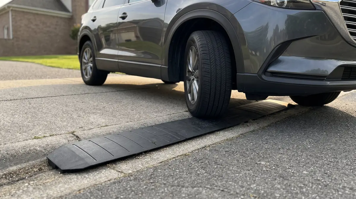 Entry Suv An SUV's front tire rolling smoothly over the Smooth Curb ramp while entering a driveway