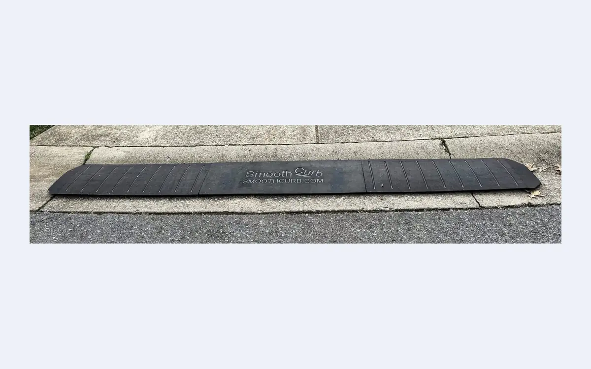 Offer Card The Smooth Curb driveway curb ramp installed on a rolled curb — studio product shot